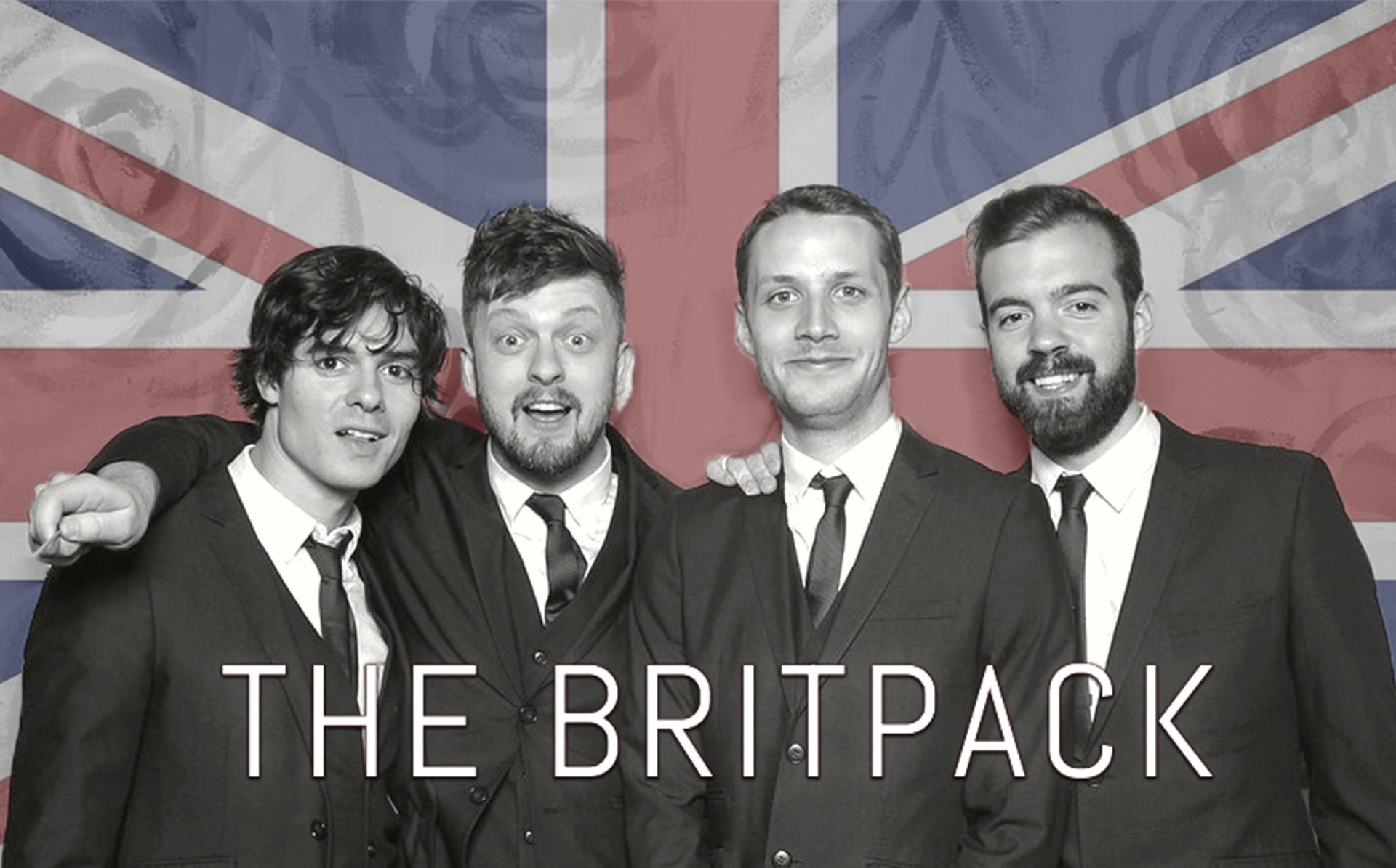 Four members of The Britpack in front of the British Flag