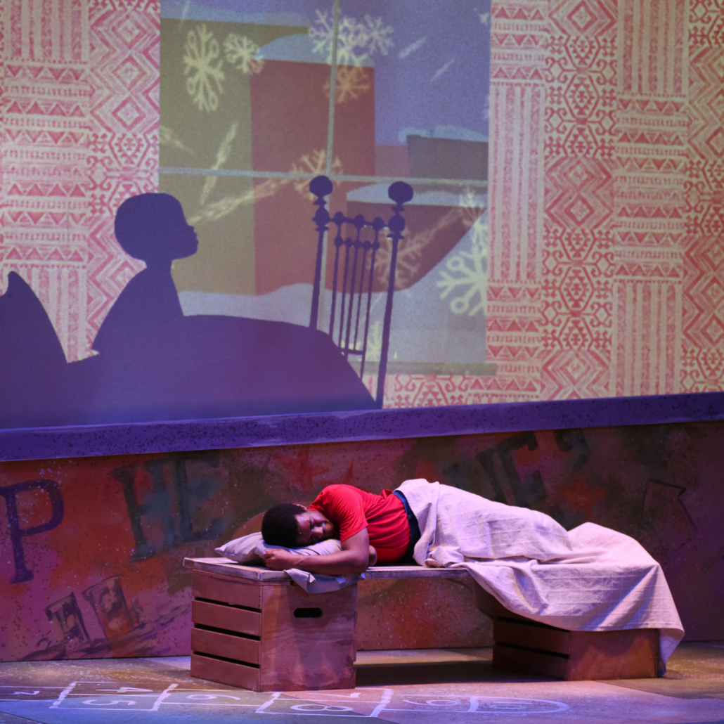 boy sleeping in a bed with a shadow of a boy sitting up in bed, on the wall