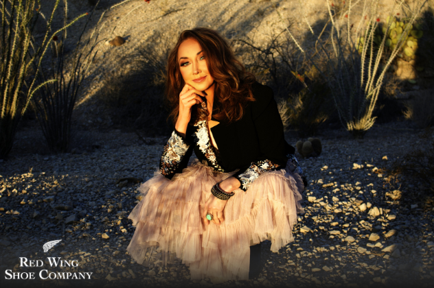 Pam Tillis - Oct 13 woman sitting on a rocky beach