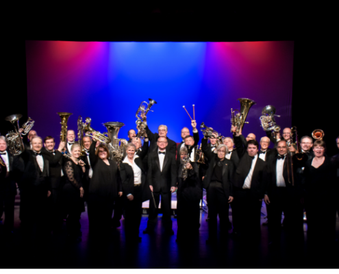 Sheldon Brass Band Holiday Concert - Nov 28 brass band on stage holding up brass instruments
