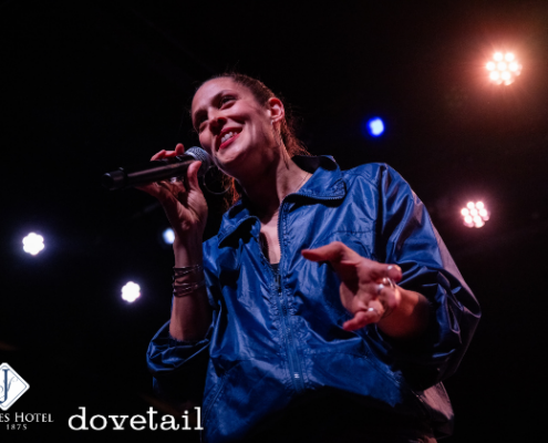 Dessa - Mar 6 woman singing into a microphone