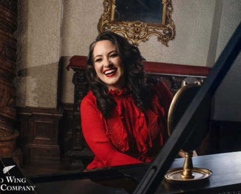 Nicole Zuraitis - Mar 13 woman smiling and playing the piano