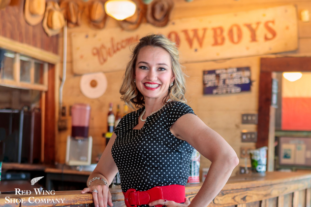 Mollie B and Friends - Apr 24 woman standing at a bar smiling