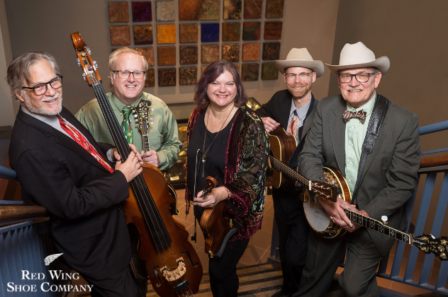 Monroe Crossing - May 15 bluegrass band holding instruments on standing on stairs